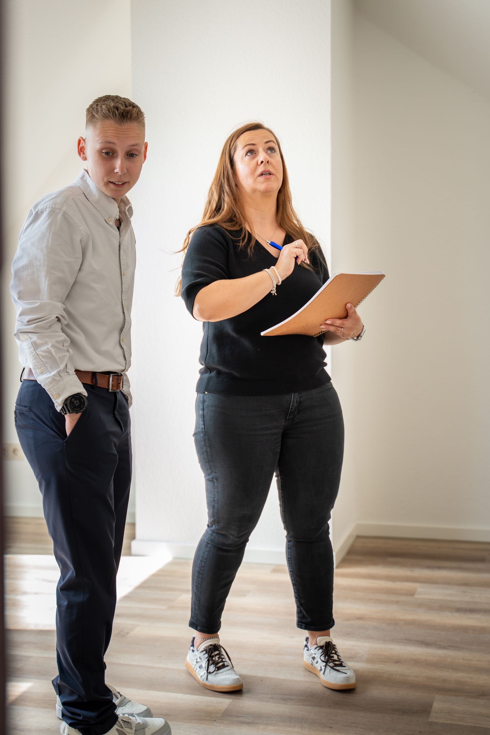 Zwei Personen bei einer Objektbegehung in einer leeren Wohnung – professionelle Mietverwaltung 