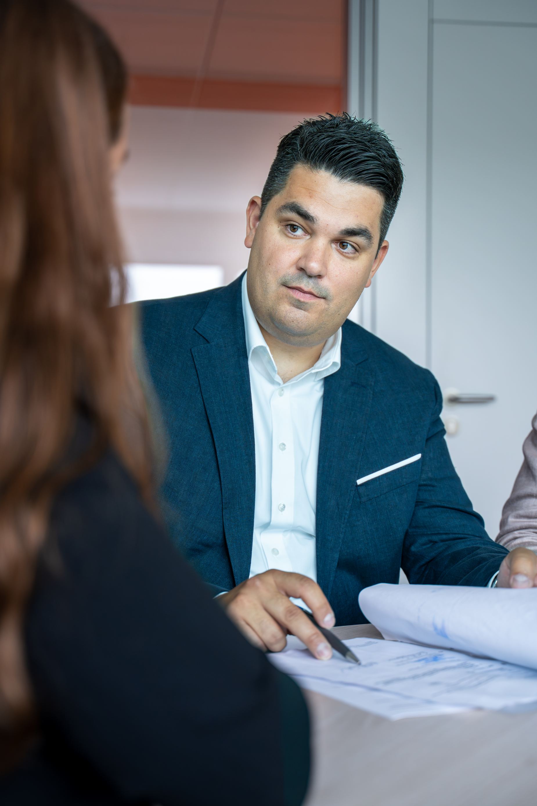 Geschäftsführung von Volksbank Immobilien GmbH Kassel Göttingen im Gespräch mit einer Kundin, Unterlagen liegen auf dem Tisch bereit 
